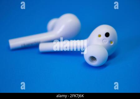 Wireless Blue-tooth Earphone or Ear bud. Air Pods wireless Blue-tooth headphones. Stock Photo