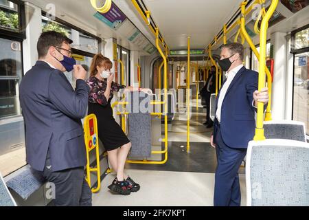 Labour leader Keir Starmer with Labour's Metro Mayor Andy Burnham and deputy leader of the Labour Party Angela Rayner, travel on a Metrolink tram, during a visit to Manchester. Picture date: Thursday April 29, 2021. Stock Photo