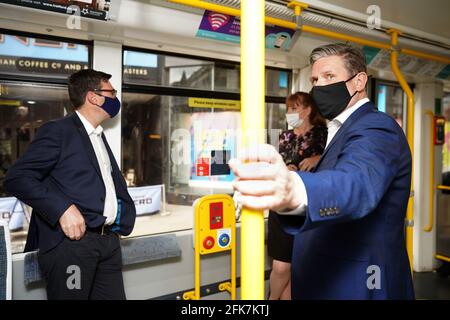 Labour leader Keir Starmer with Labour's Metro Mayor Andy Burnham and deputy leader of the Labour Party Angela Rayner travel on a Metrolink tram, during a visit to Manchester. Picture date: Thursday April 29, 2021. Stock Photo