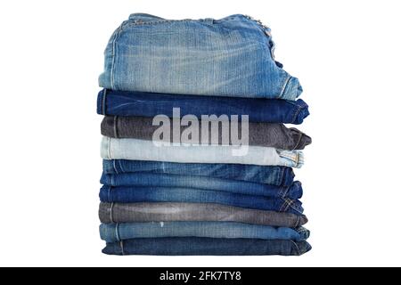 Stack of folded clothes, blue jeans pants, dark blue denim trousers isolated on white background Stock Photo