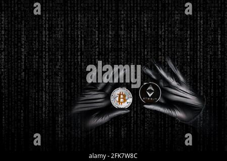 Hands in a black gloves holding bitcoin and Ethereum coin. International hacker is trying to steel your crypto currencys. Blockchain security. Thief with laptop is hacking governments computers. Phishing attacks.  Stock Photo