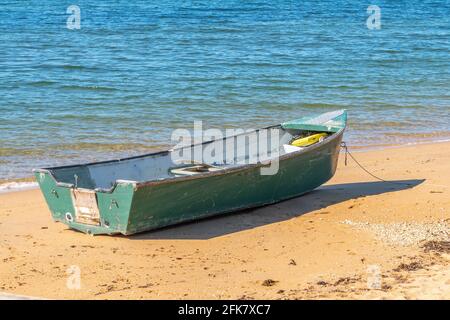 Small green boat on the beach at Margate, Queensland, Australia Stock Photo