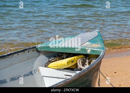 Small green boat on the beach at Margate, Queensland, Australia Stock Photo