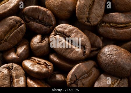Brown roasted coffee beans close up full frame as a background Stock Photo