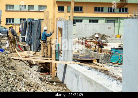 Civil Engineer inspecting and instructing construction workers on the job. Stock Photo