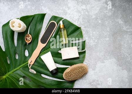 Spa composition with body care items and plants on a gray background. Top view. Stock Photo