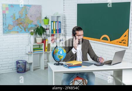 formal education. knowledge day. mature bearded teacher at lesson. brutal man work in classroom with blackboard. prepare for exam. college lecturer on Stock Photo