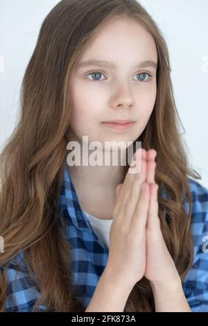 Little girl praying on white background Stock Photo - Alamy
