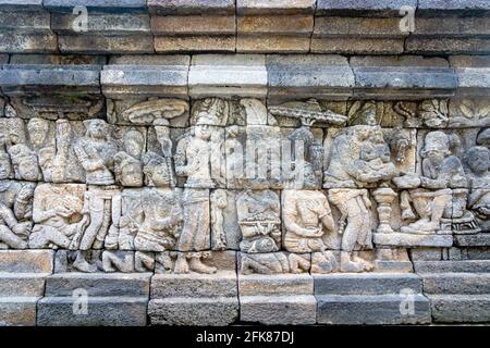 Carved relief at Borobudur on Java Indonesia. Borobudur is a Buddhist stupa and temple complex in Central Java and a UNESCO World Heritage Site. Stock Photo
