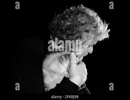 Beppe Grillo affectionately embraces an elderly person-Italian comedian leader of the Movimento Cinque Stelle M5S - concept of retirement Stock Photo