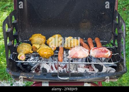 BBQ fire over the hot coals with meat assortment Stock Photo