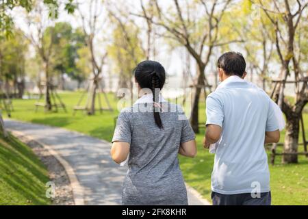 Senior couple in cooper wearing protective mask, Just keep going Stay active, stay well Stock Photo