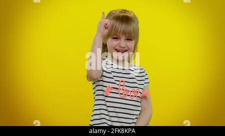 Inspired kid make gesture raises finger came up with creative plan feels excited with good idea Stock Photo