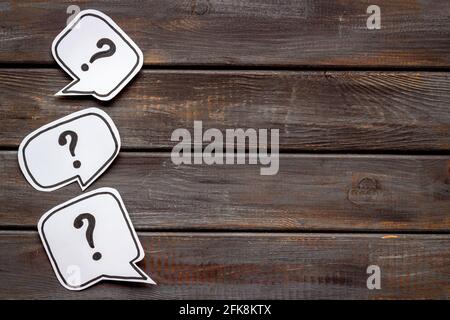 Ask question concept. Question mark on speech bubbles, top view Stock Photo