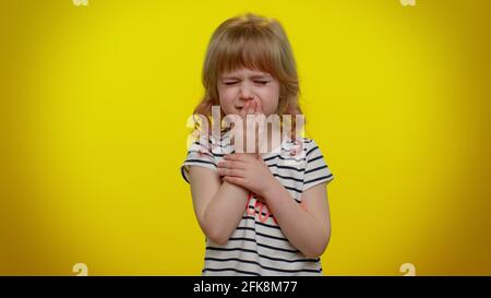 Unhealthy child kid girl coughing covering mouth, feeling sick, allergy or viral infection symptoms Stock Photo