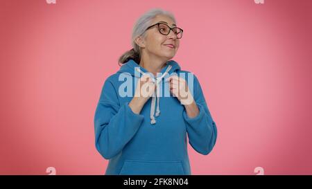 Ambitious senior woman winner of lottery posing for photographers, successful famous rich person Stock Photo