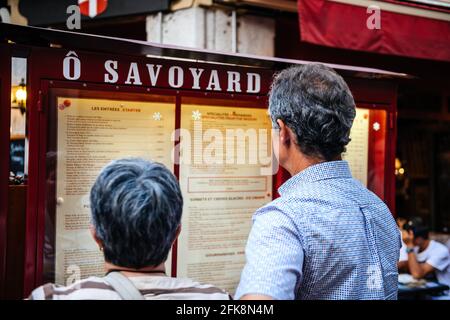 Rear view of customers reading menu at the O Savoyard restaurant Stock Photo