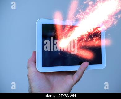 Male hand holding isolated on blue background the new Amazon Echo 8 Stock Photo