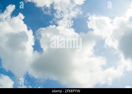 The gray and white clouds floating under a blue sky, stirred by the winds, which shape them in curious shapes. Stock Photo