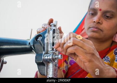 CLOSE-UP RURAL WOMAN using sewing machine Stock Photo