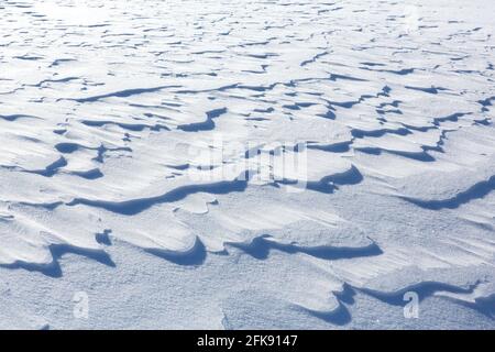 Wind-induced snow crusts on plain in winter Stock Photo