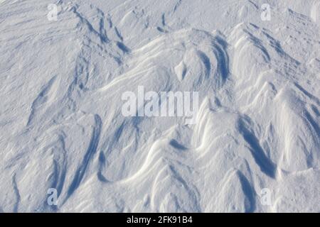 Wind-induced snow crusts on plain in winter Stock Photo