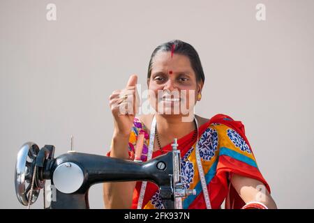 Rural woman Worker Tailor showing Thumbs Up Stock Photo