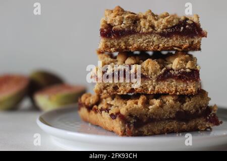 Home baked Fig crumble bars made of fresh figs and whole wheat flour. Shot on white background. Stock Photo