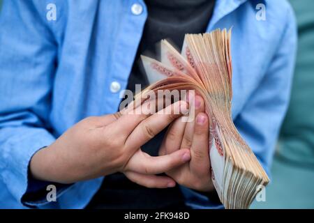 hands close-up consider a large currency of Russian rubles Stock Photo