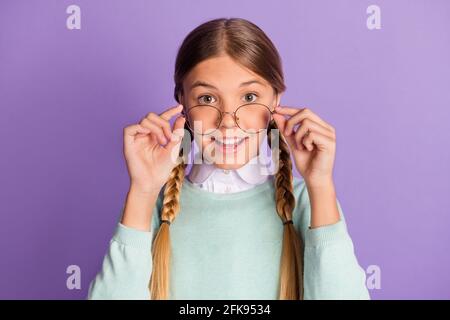 Photo of small lady toothy smile look camera take off specs wear green sweater isolated purple background Stock Photo