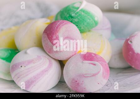Closeup of colorful little meringues on a white plate Stock Photo