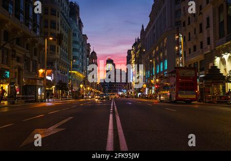 MADRID - AUGUST 4, 2016: Low-angle view of Madrid's busy Gran Vía street at dusk, with Callao and the Edificio Carrion with the Schweppes sign glowing Stock Photo