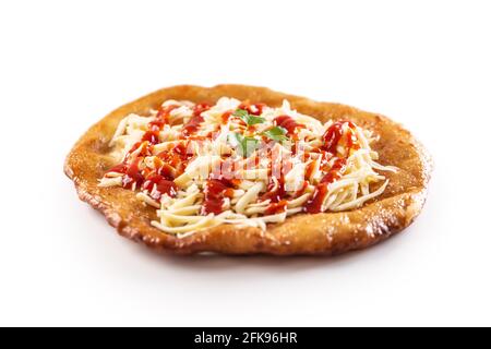 Lovely hungarian traditional langos served with grated cheese, ketchup, gaerlic and green herb. Stock Photo
