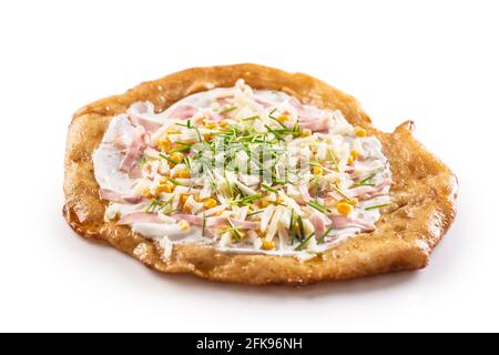 Crusty hungarian langos with cream, ham, grated cheese, corn and greased with garlic. Stock Photo