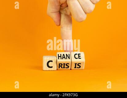 Crisis or chance symbol. Businessman turns cubes and changes the word 'crisis' to 'chance'. Beautiful orange background, copy space. Business and cris Stock Photo