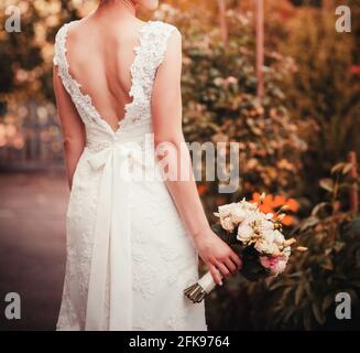 beautiful colorful wedding bouquet in a hand of a bride Stock Photo
