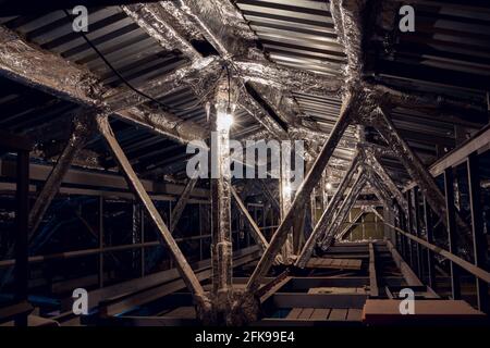 Foil insulation. Insulation of the steel frame of the building with insulation with foil. Insulation with foil. Protection of the building from heat l Stock Photo