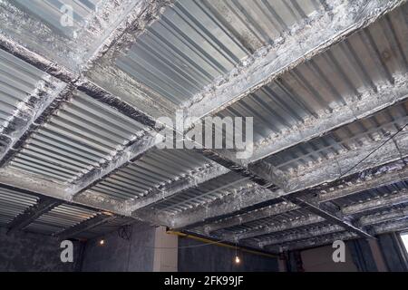 Foil insulation. Insulation of the steel frame of the building with insulation with foil. Insulation with foil. Protection of the building from heat l Stock Photo
