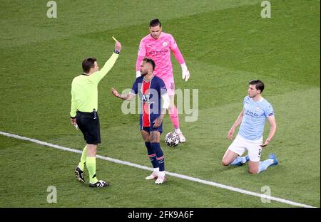 Neymar Jr of PSG receives a yellow card from referee Felix Brych of Germany while goalkeeper of Manchester City Ederson Moraes and Ruben Dias of Manchester City look on during the UEFA Champions League, Semi Final, 1st leg football match between Paris Saint-Germain and Manchester City on April 28, 2021 at Parc des Princes stadium in Paris, France - Photo Jean Catuffe / DPPI Stock Photo