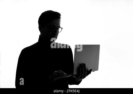 Man typing on laptop computer, isolated on white background. Stock Photo