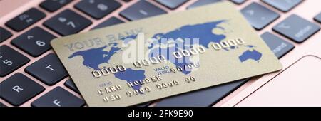 Credit bank card lying on laptop keyboard closeup Stock Photo