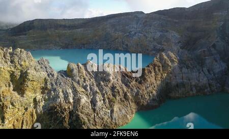 View of the crater wall above the turquoise lake Kootainuamuri. Kelimutu - Turquoise colored volcanic lake Stock Photo