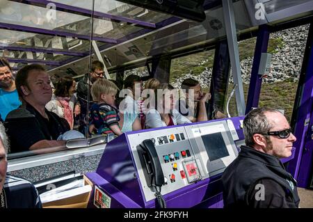 Passengers on board the Cairngorm Funicular railway as they head up the Cairngorm mountain toits top station. Stock Photo