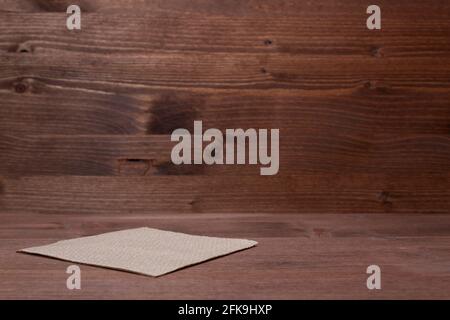 Isolated brown paper napkin on wooden background. Space for texr. Copy space. Stock Photo
