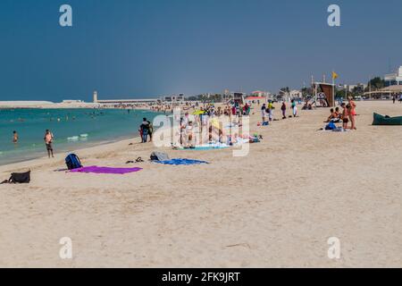 DUBAI, UAE - OCTOBER 21, 2016: People at Public beach Jumeirah in Dubai, United Arab Emirates Stock Photo