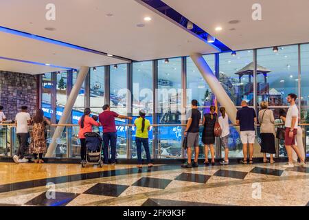 DUBAI, UAE - OCTOBER 21, 2016: People watch Ski Dubai, indoor ski resort in Mall of Emirates shopping mall in Dubai, United Arab Emirates Stock Photo