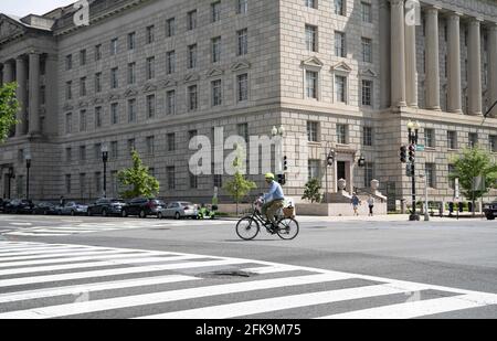Washington, USA. 29th Apr, 2021. A man rides a bicycle past the U.S. Commerce Department in Washington, DC, the United States, on April 29, 2021. The U.S. economy grew at an annual rate of 6.4 percent in the first quarter of 2021, the U.S. Commerce Department reported Thursday. Credit: Liu Jie/Xinhua/Alamy Live News Stock Photo