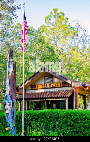A wooden Indian princess stands with an American flag at the entrance to Indian Point RV Resort, April 25, 2021, in Gautier, Mississippi. Stock Photo