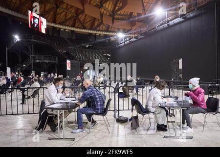 Bologna, Italy. 29th Apr, 2021. Vaccinees sit at the registration desks inside the Unipol Arena on April 29, 2021 in Bologna, Italy. Credit: Massimiliano Donati/Alamy Live News Stock Photo