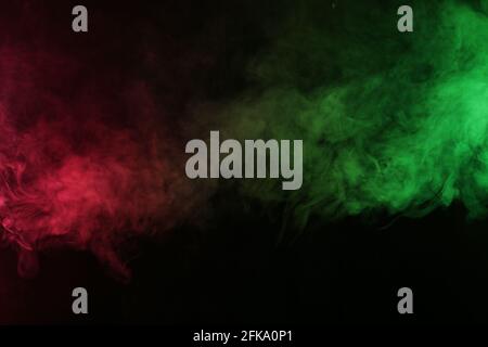 Smoke in red-green light on black background Stock Photo